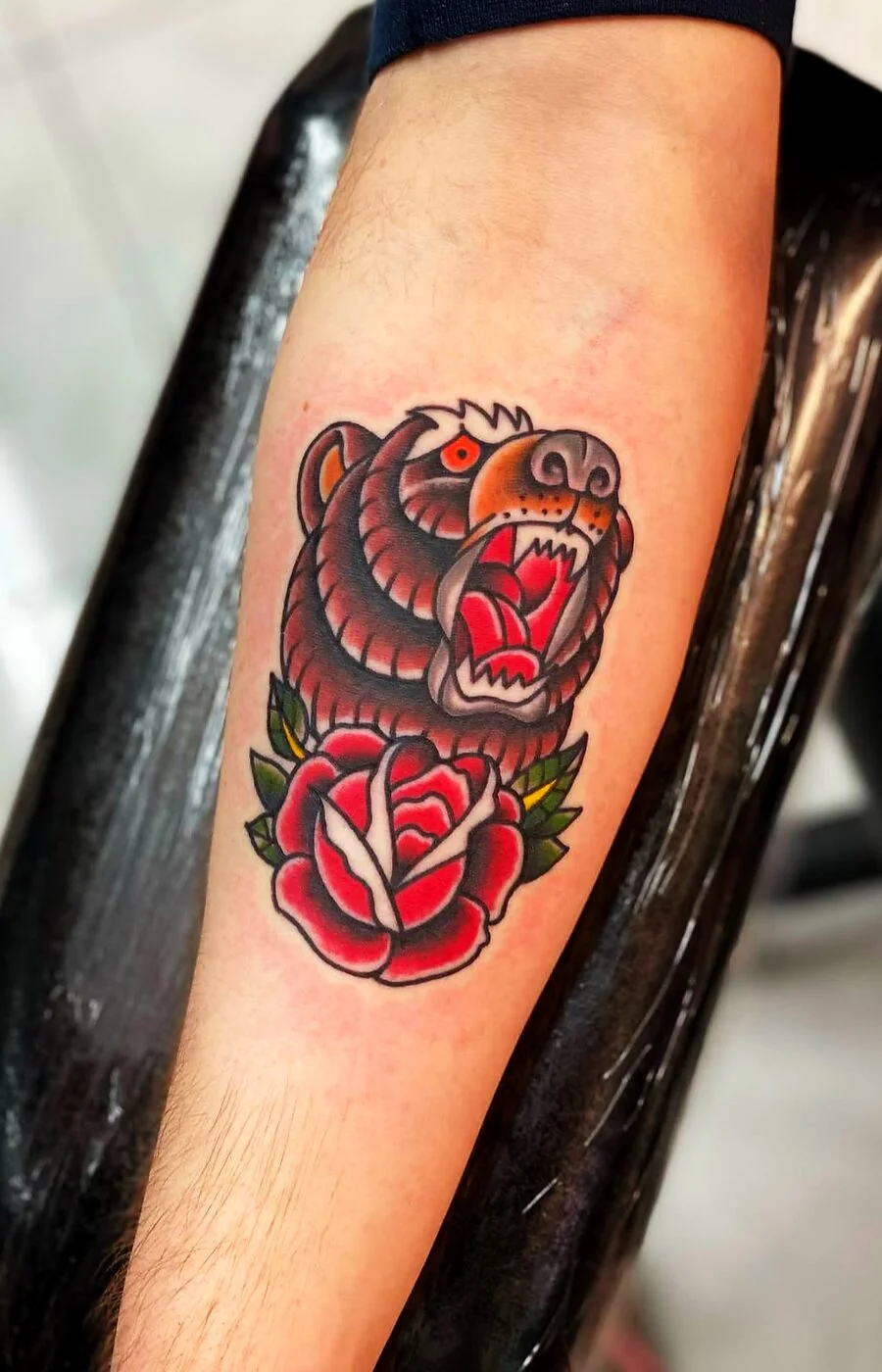 American Traditional roaring bear head with rose tattoo on forearm by 2bit (Chris Curren) at Lost at Sea Tattoo, Chinatown, Honolulu American Traditional roaring bear head with rose tattoo on forearm by 2bit (Chris Curren) at Lost at Sea Tattoo, Chinatown, Honolulu