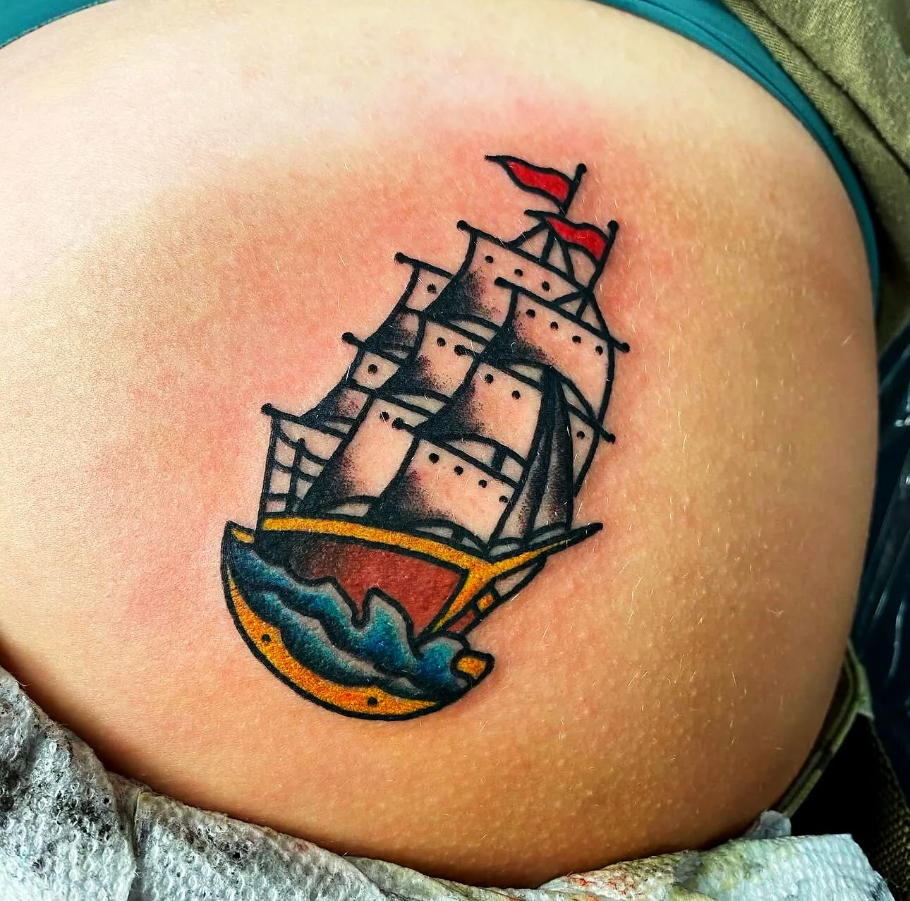 American Traditional sailing ship with red flag tattoo on hip by 2bit (Chris Curren) at Lost at Sea Tattoo, Chinatown, Honolulu American Traditional sailing ship with red flag tattoo on hip by 2bit (Chris Curren) at Lost at Sea Tattoo, Chinatown, Honolulu