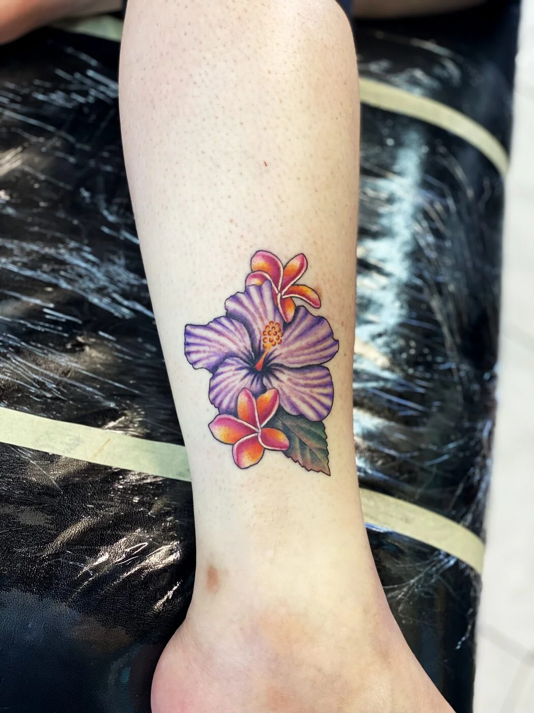 Color Realism purple hibiscus and plumeria tattoo on ankle by 2bit (Chris Curren) at Lost at Sea Tattoo, Chinatown, Honolulu Color Realism purple hibiscus and plumeria tattoo on ankle by 2bit (Chris Curren) at Lost at Sea Tattoo, Chinatown, Honolulu